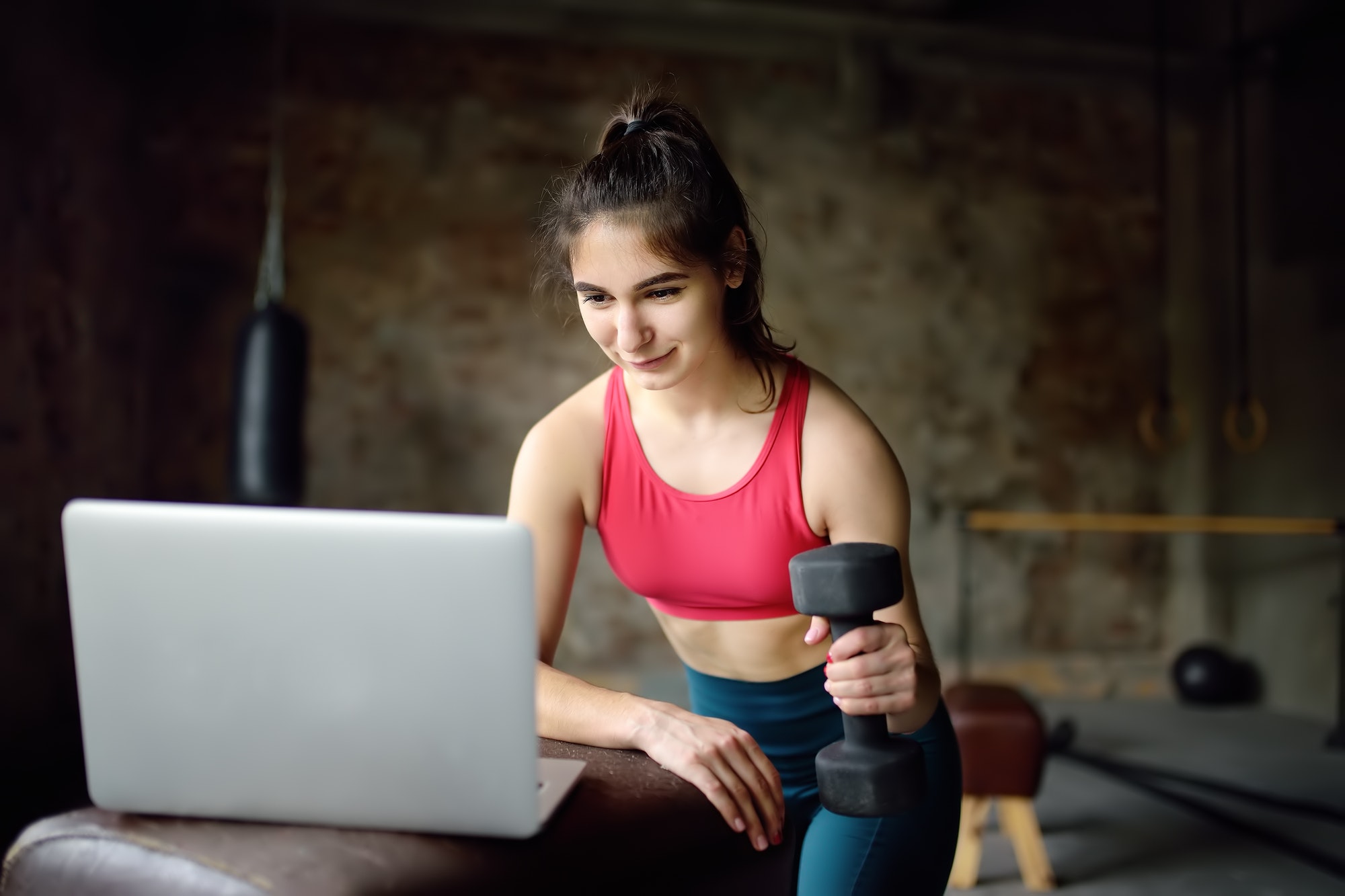 sportswoman-leads-online-fitness-class-or-herself-doing-training-using-a-laptop.jpg